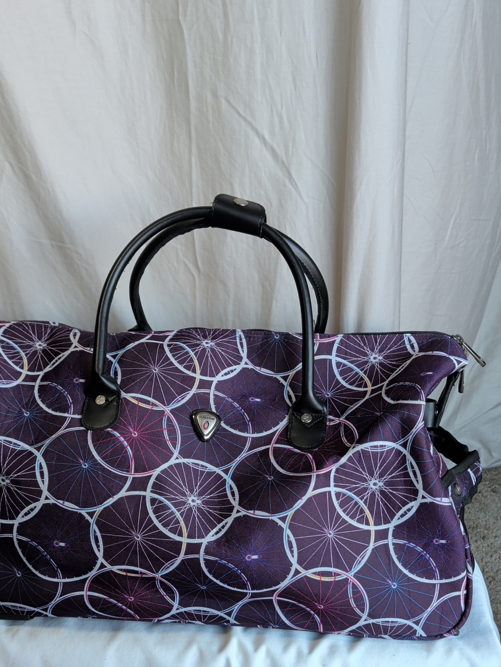 Calpak Purple Patterned Travel Bag with Black Handles And Wheels For Convience